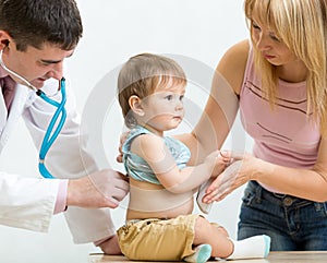 Pediatrician doctor examining child. Mother supporting kid.