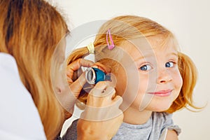 Pediatrician doctor examining girl