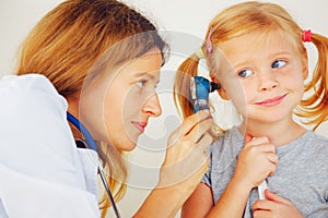 Pediatrician doctor examining girl