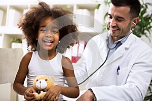 Pediatrician doctor examining kid