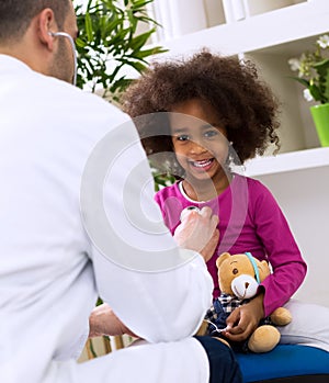 Pediatrician doctor examining kid