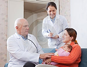 Pediatrician doctor examining three months baby