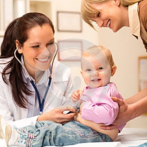 Pediatrician examine baby with stethoscope photo