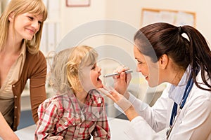 Pediatrician examine child throat look with light