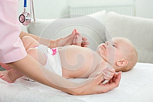 Pediatrician examines baby