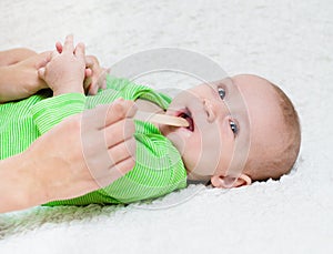 Pediatrician examines a newborn baby with a spatula