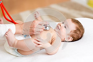 Pediatrician examines three months baby boy