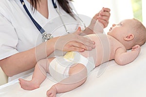 Pediatrician examining baby