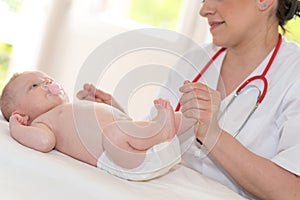 Pediatrician examining baby