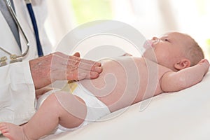 Pediatrician examining baby