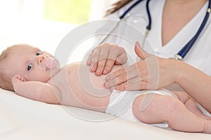 Pediatrician examining baby