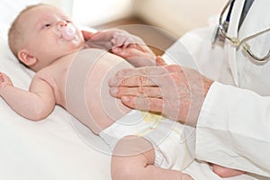 Pediatrician examining baby