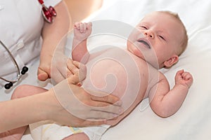 Pediatrician examining baby