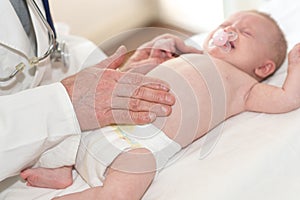 Pediatrician examining baby