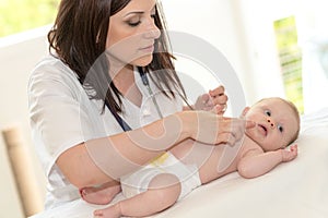 Pediatrician examining baby