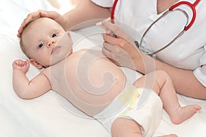 Pediatrician examining baby