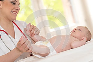 Pediatrician examining baby