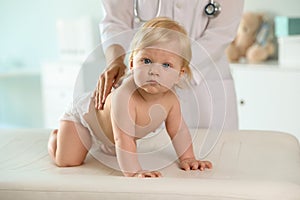 Pediatrician examining baby. Health care