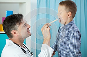 Pediatrician examining boy's throat