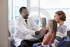 Pediatrician Examining Child In Hospital photo