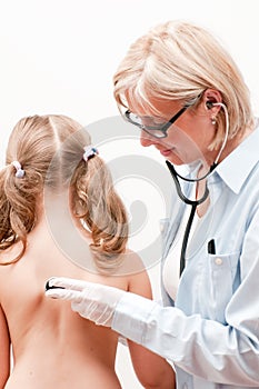 Pediatrician examining little girl