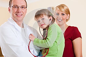 Pediatrician with family in his surgery