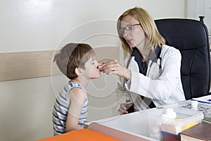 Pediatrician Giving Cough Syrup To Sick Boy In The Consulting Room