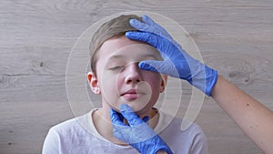 Pediatrician in Latex Nitrile Gloves Examines Eyeball, Teeth, Mouth of a Boy. 4K