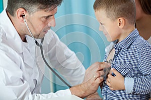 Pediatrician listening preschooler heart photo