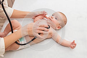 Pediatrician listens to newborn. physical examination of a small child