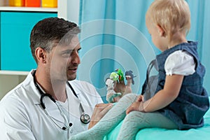 Pediatrician making baby laugh