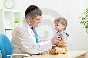 Pediatrician man examining heartbeat of baby boy