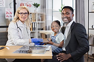 Pediatrician monitoring saturation of cute african girl