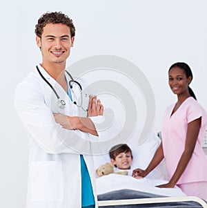 Pediatrician and nurse attending to a child