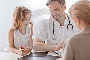 Pediatrician and sick boy in a doctor`s office