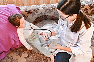 Pediatrician with a small patient at home. inspection of the baby