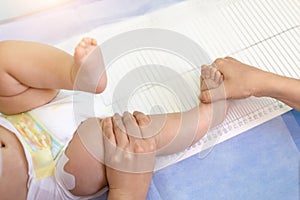 Pediatrician specialist taking measurement of infant child height during screening examination. Doctor or nurse holding