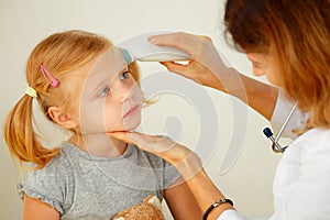 Pediatrician taking temperature