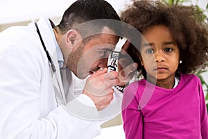 Pediatrician using otoscope
