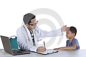 Pediatrician writing a prescription for his patient