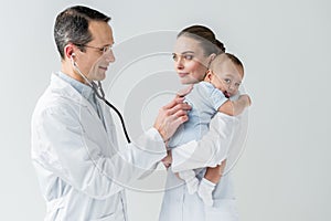 pediatricians examining little baby breath