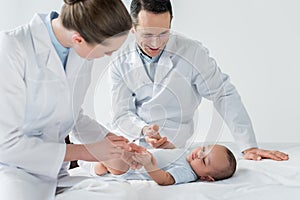 pediatricians preparing to perform vaccination to