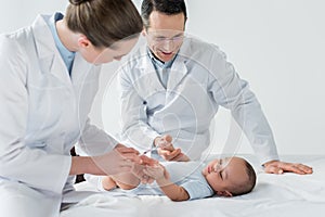 pediatricians preparing to perform vaccination to photo