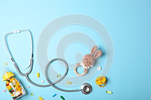 Pediatrics concept. Stethoscope and toy on a light background