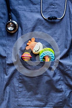 Pediatrics pocket with toys on blue background top view space for text