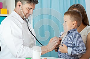 Pediatrist examinate patient with stethoscope photo