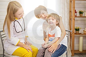 Pediatrist examinate young patient`s lungs with stethoscope