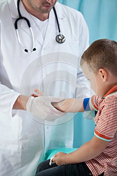Pediatrist make an injection photo
