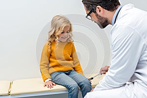 pediatrist making neurology examination for smiling