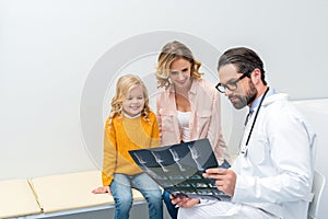 pediatrist showing x-ray to woman photo